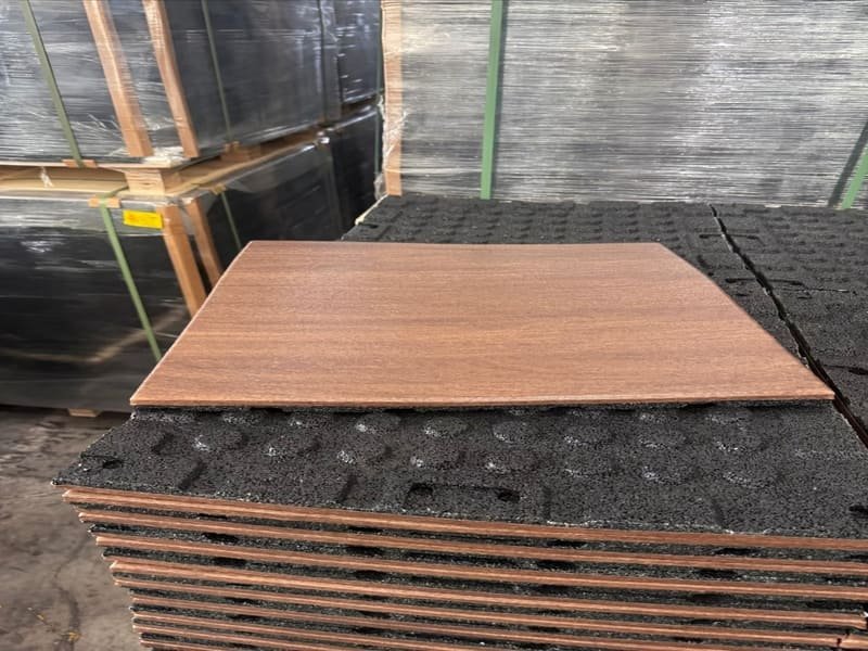 Rubber gym flooring rolls, tiles, and mats being manufactured